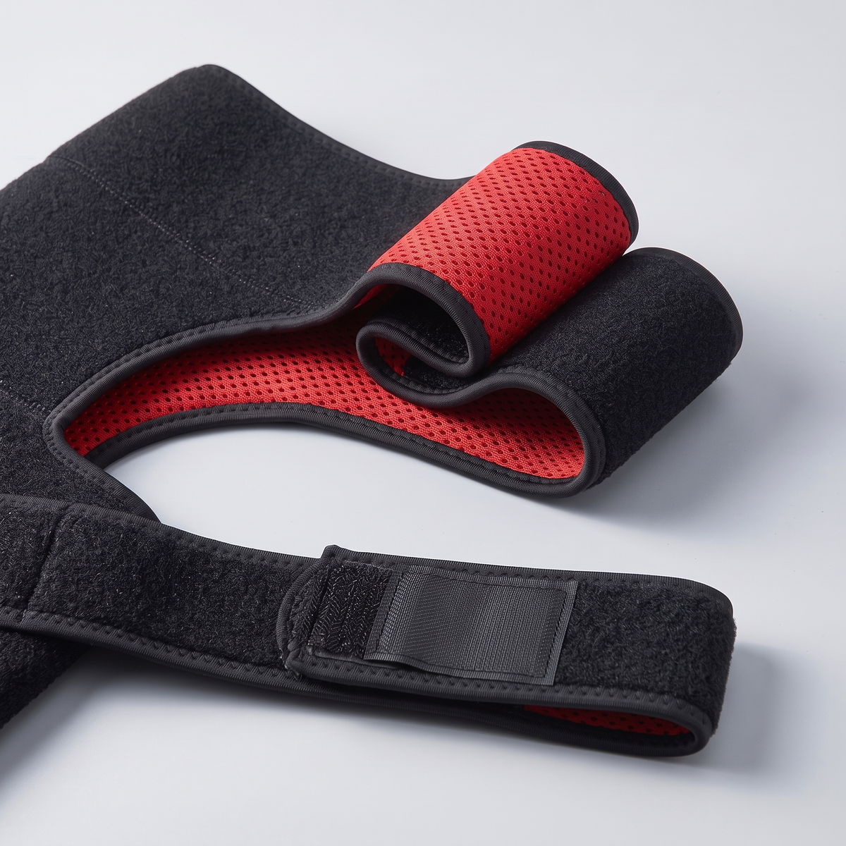 The neoprene folded back to show the perforated mesh lining inside